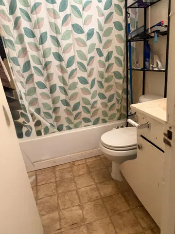 a bathroom with a toilet and a shower