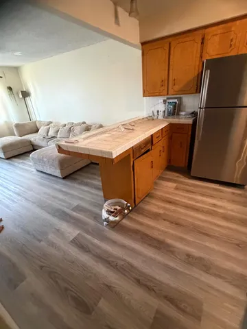 a kitchen with a sink cabinets and wooden floor
