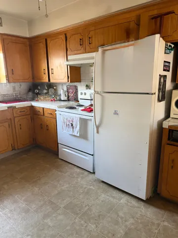 a utility room with cabinets washer and dryer