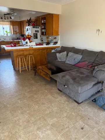a living room with furniture and a kitchen view