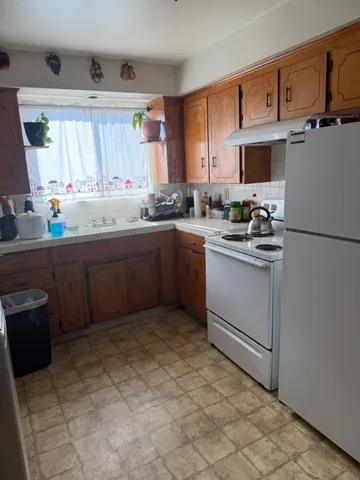 a kitchen with a sink stove and cabinets