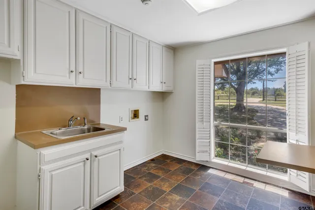 a kitchen with a sink and cabinets
