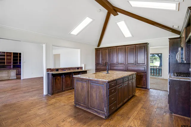 a kitchen with a stove and wooden cabinets