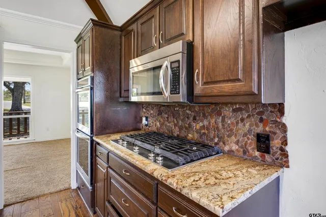 a stove top oven sitting inside of a kitchen
