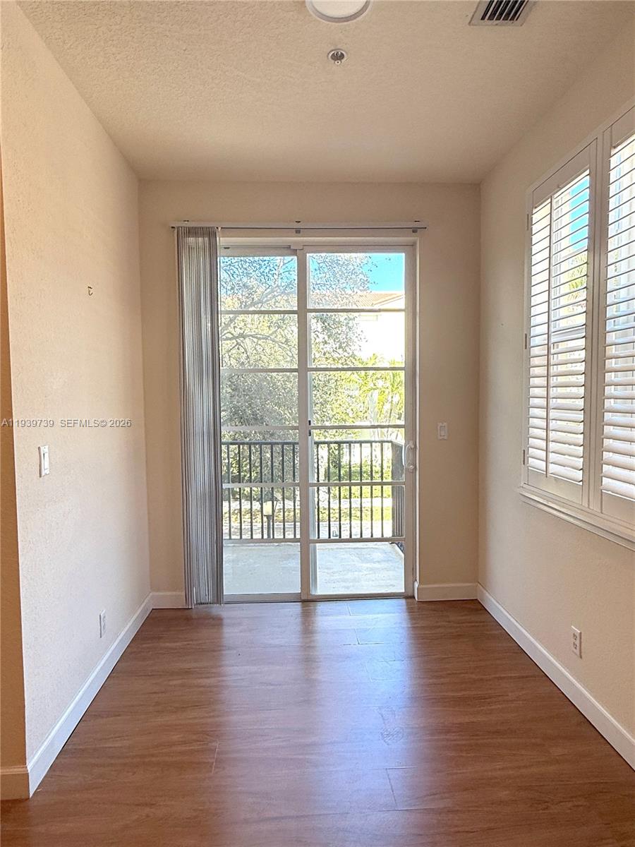 120 Cat Rock Lane Jupiter, FL 33458 - Photo 23 of 28 wooden floor in an empty room with a window