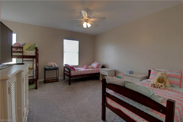 a bedroom with a bed dresser and a window