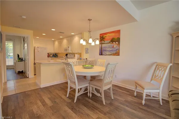 a view of a dining room with furniture wooden floor and a chandelier