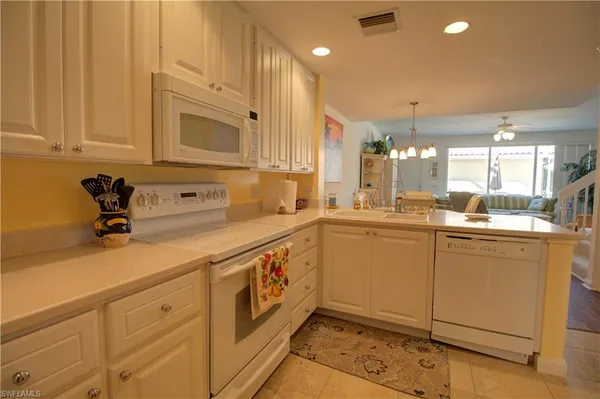 a kitchen with sink cabinets and appliances