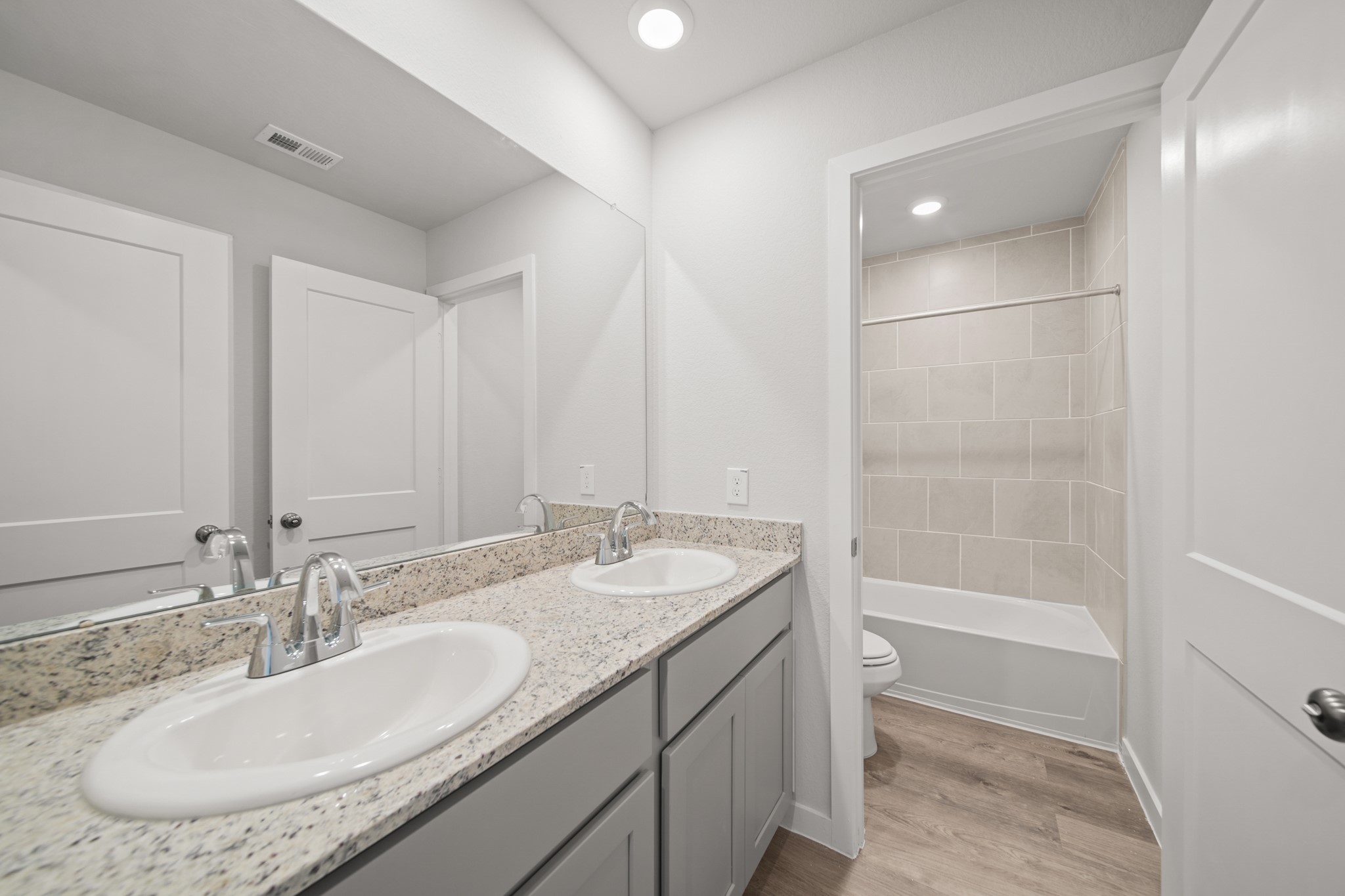 305 Bennett Street Angleton, TX 77515 - Photo 19 of 27 a bathroom with a granite countertop sink and a mirror