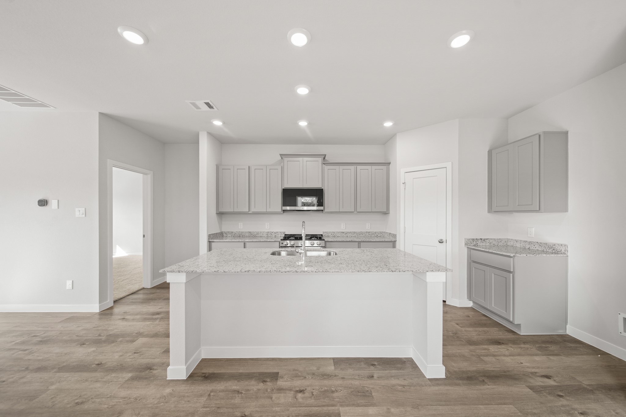 305 Bennett Street Angleton, TX 77515 - Photo 4 of 27 a view of a kitchen with kitchen island a sink stainless steel appliances and cabinets