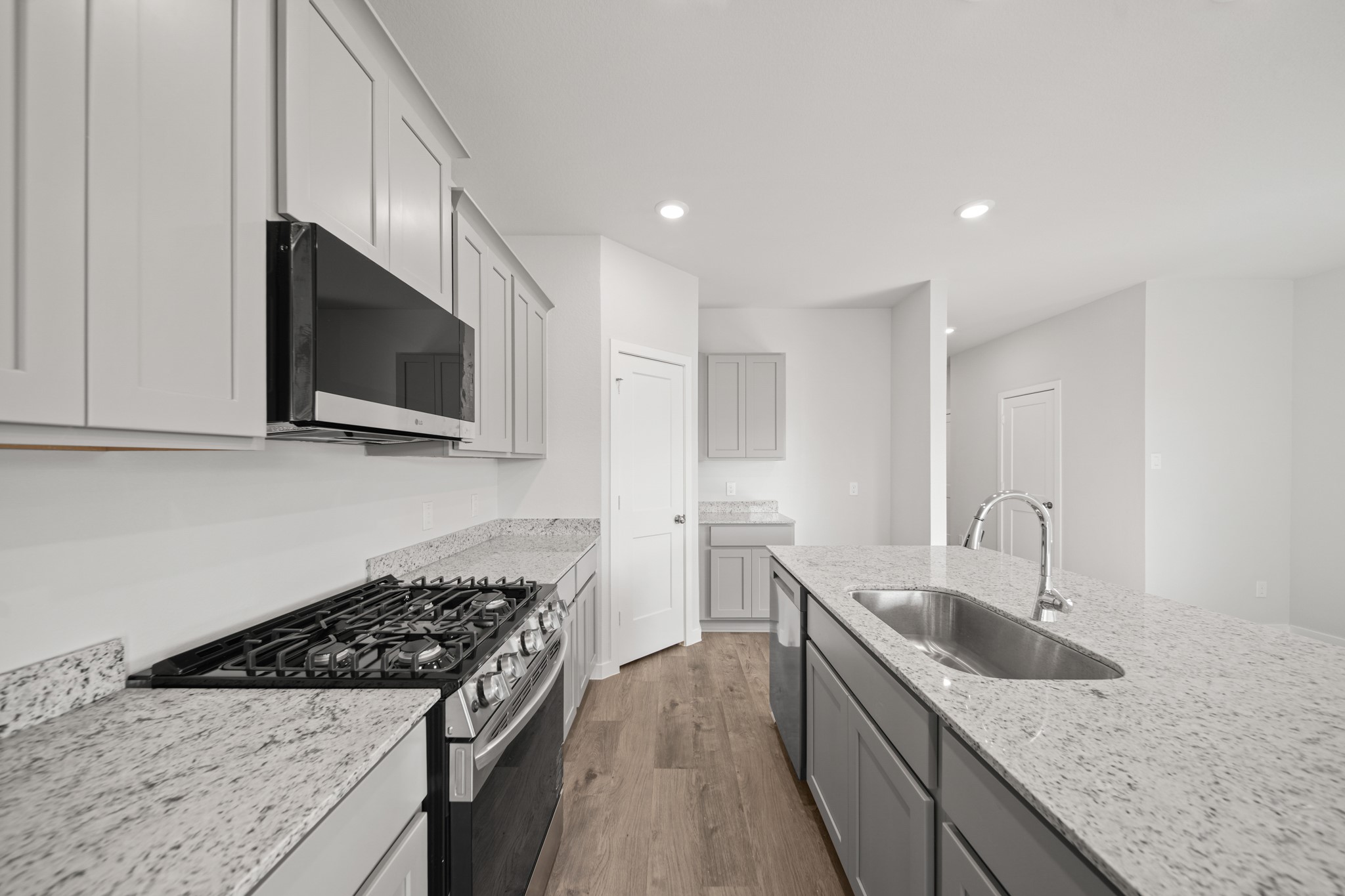 305 Bennett Street Angleton, TX 77515 - Photo 5 of 27 a kitchen with stainless steel appliances granite countertop a sink a stove top oven a counter space and cabinets