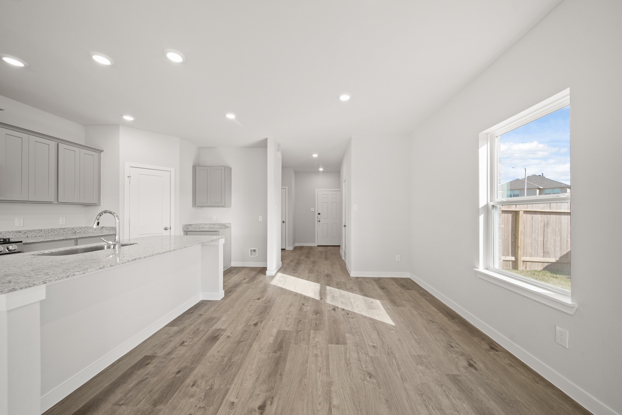 305 Bennett Street Angleton, TX 77515 - Photo 6 of 27 a large kitchen with a lot of white cabinets and wooden floor