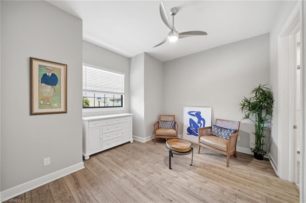 9658 Montelanico Loop, Unit 201 Naples, FL 34119 - Photo 21 of 46 a living room with furniture and a wooden floor