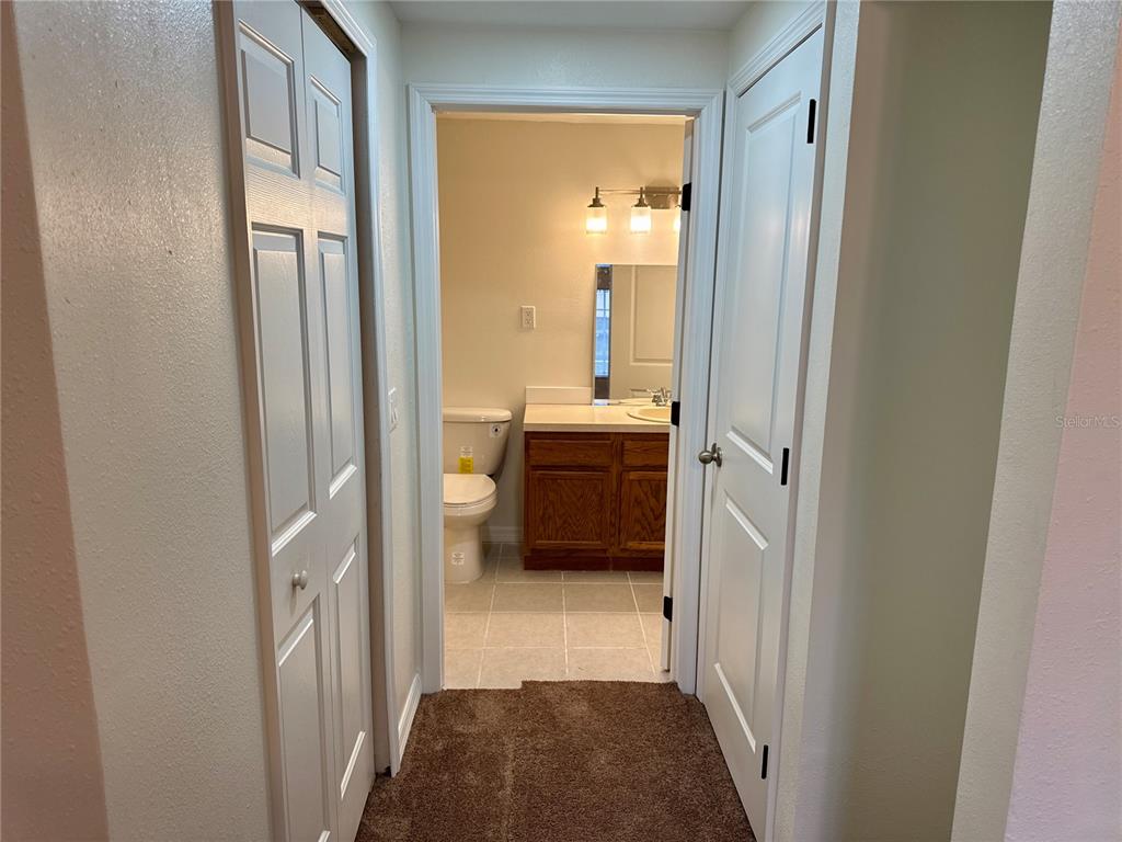 9515 Grovedale Circle, Unit 101 Riverview, FL 33578 - Photo 11 of 22 a view of a bathroom from a hallway