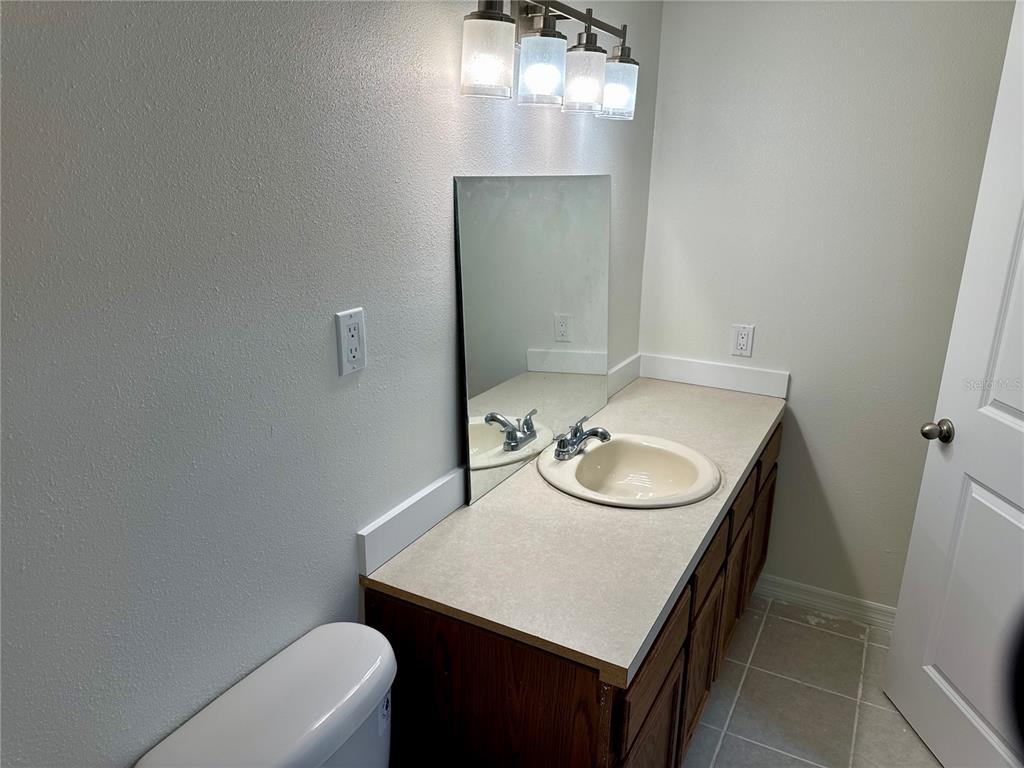 9515 Grovedale Circle, Unit 101 Riverview, FL 33578 - Photo 12 of 22 a bathroom with a sink and a mirror