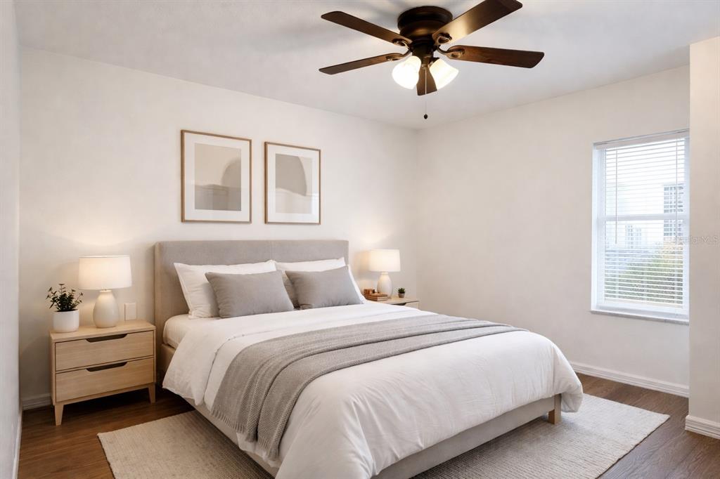 9515 Grovedale Circle, Unit 101 Riverview, FL 33578 - Photo 14 of 22 a bedroom with a large bed and a window