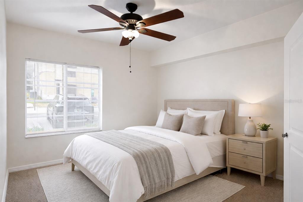 9515 Grovedale Circle, Unit 101 Riverview, FL 33578 - Photo 16 of 22 a bedroom with a large bed and a window