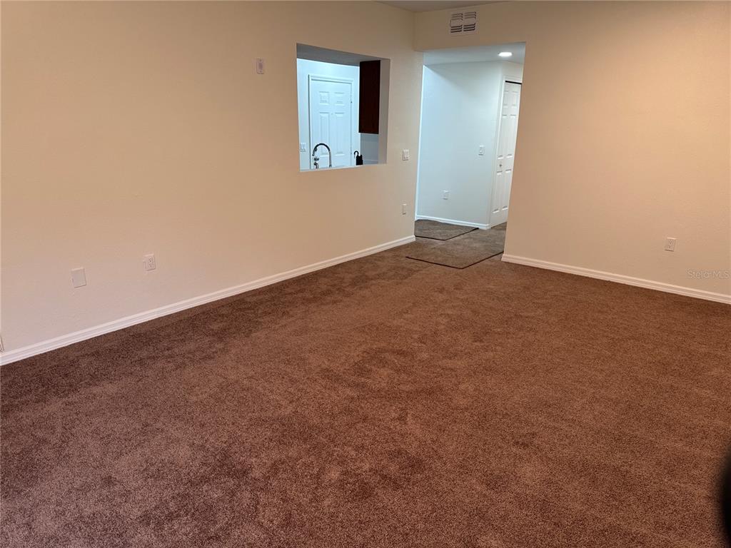 9515 Grovedale Circle, Unit 101 Riverview, FL 33578 - Photo 5 of 22 an empty room with mirror