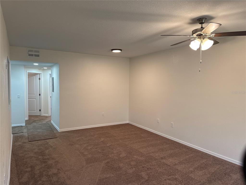 9515 Grovedale Circle, Unit 101 Riverview, FL 33578 - Photo 8 of 22 a view of a room with a chandelier fan