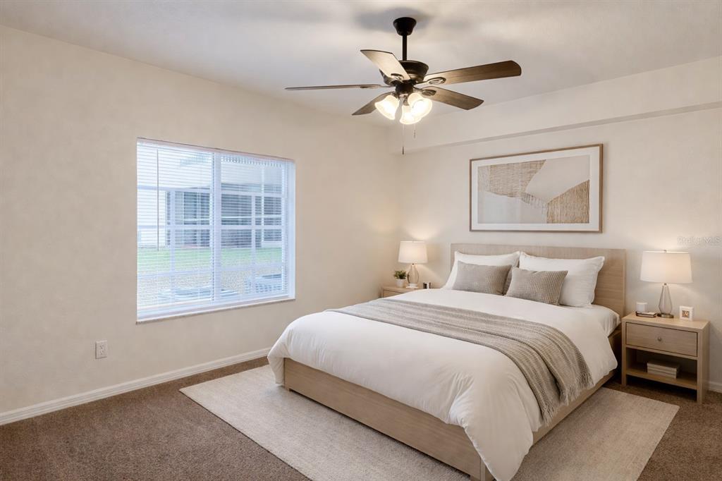 9515 Grovedale Circle, Unit 101 Riverview, FL 33578 - Photo 9 of 22 a bedroom with a large bed and a window