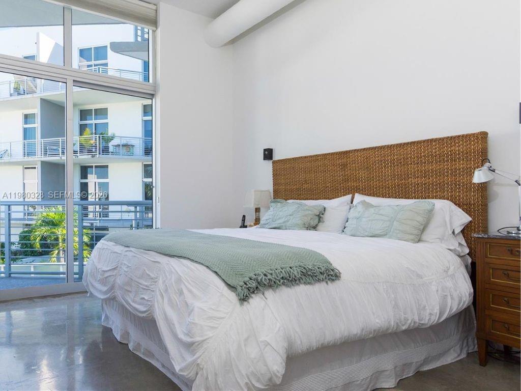 2001 Meridian Avenue, Unit 414 Miami Beach, FL 33139 - Photo 11 of 22 a bed sitting in a bedroom next to a window