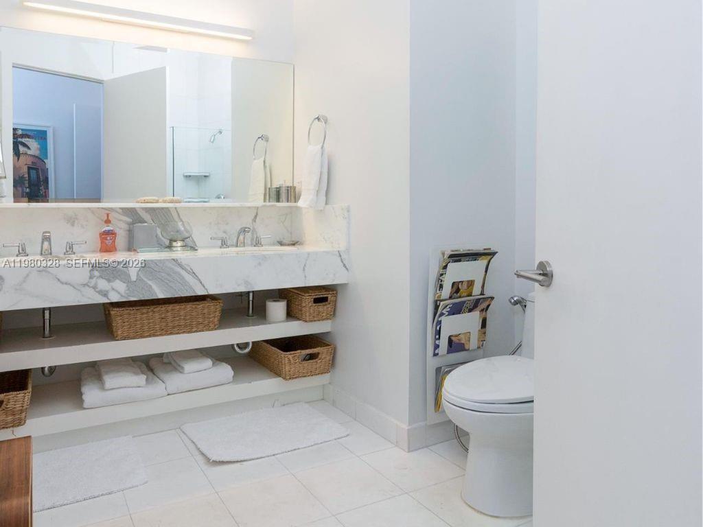 2001 Meridian Avenue, Unit 414 Miami Beach, FL 33139 - Photo 14 of 22 a bathroom with a sink a toilet and a mirror
