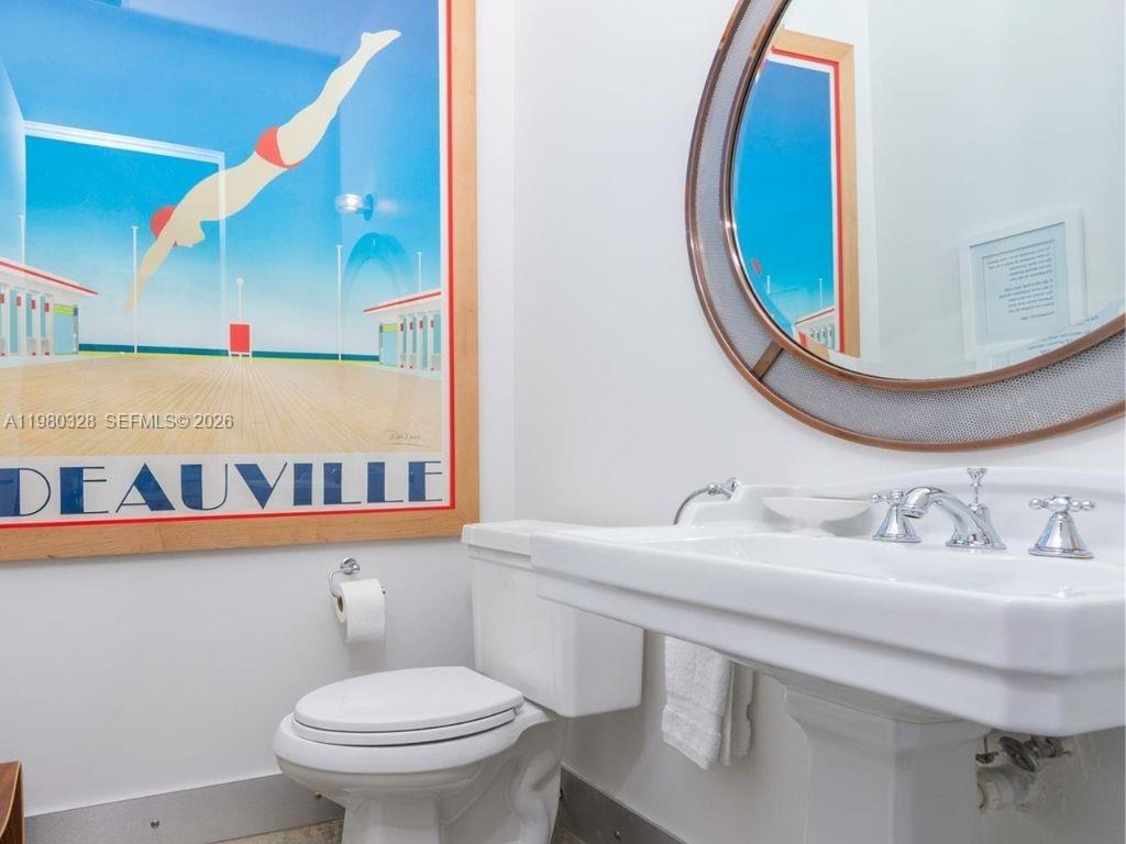 2001 Meridian Avenue, Unit 414 Miami Beach, FL 33139 - Photo 15 of 22 a bathroom with a sink and a mirror