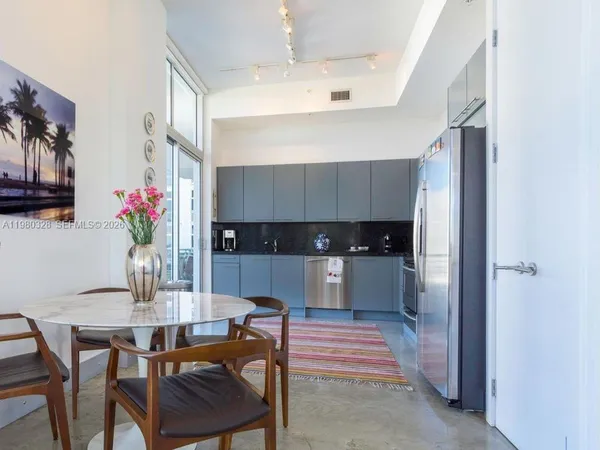 a kitchen with a table and chairs in it