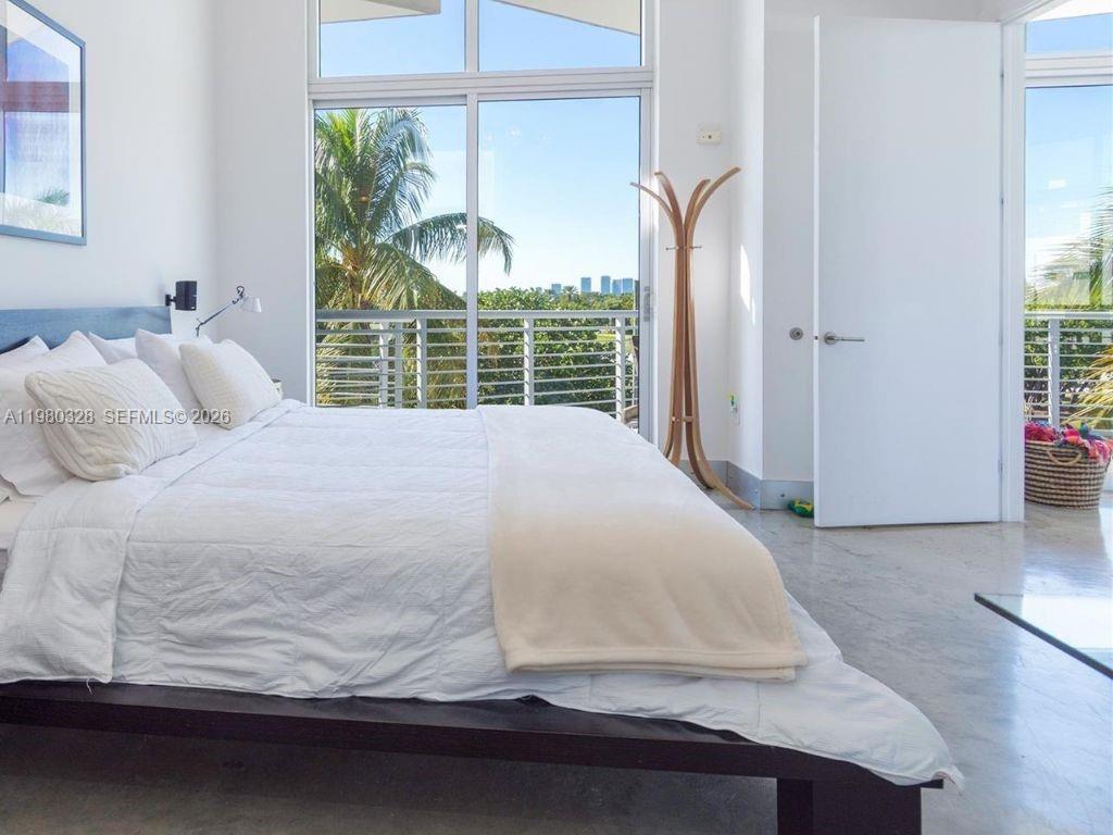 2001 Meridian Avenue, Unit 414 Miami Beach, FL 33139 - Photo 10 of 22 a large white bed sitting in a bedroom next to a window