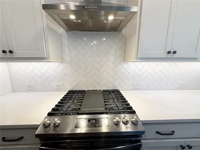 a stove sitting inside of a kitchen