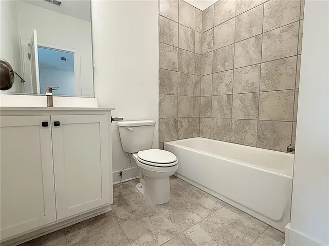 a bathroom with a toilet a sink and bathtub