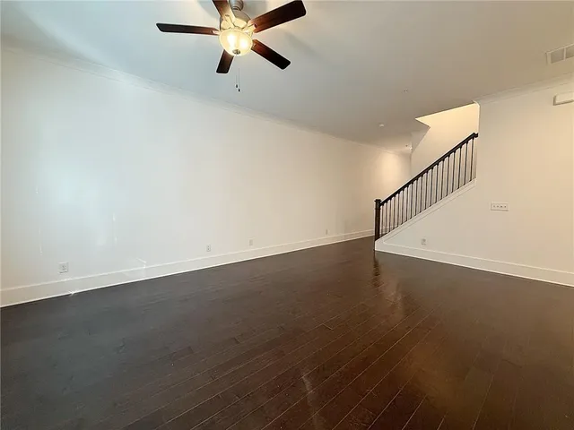 a view of a room with wooden floor and windows