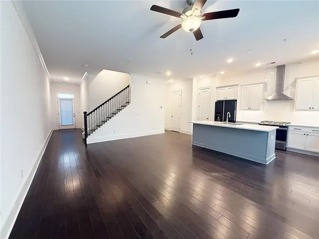 a view of a kitchen with sink and wooden floor