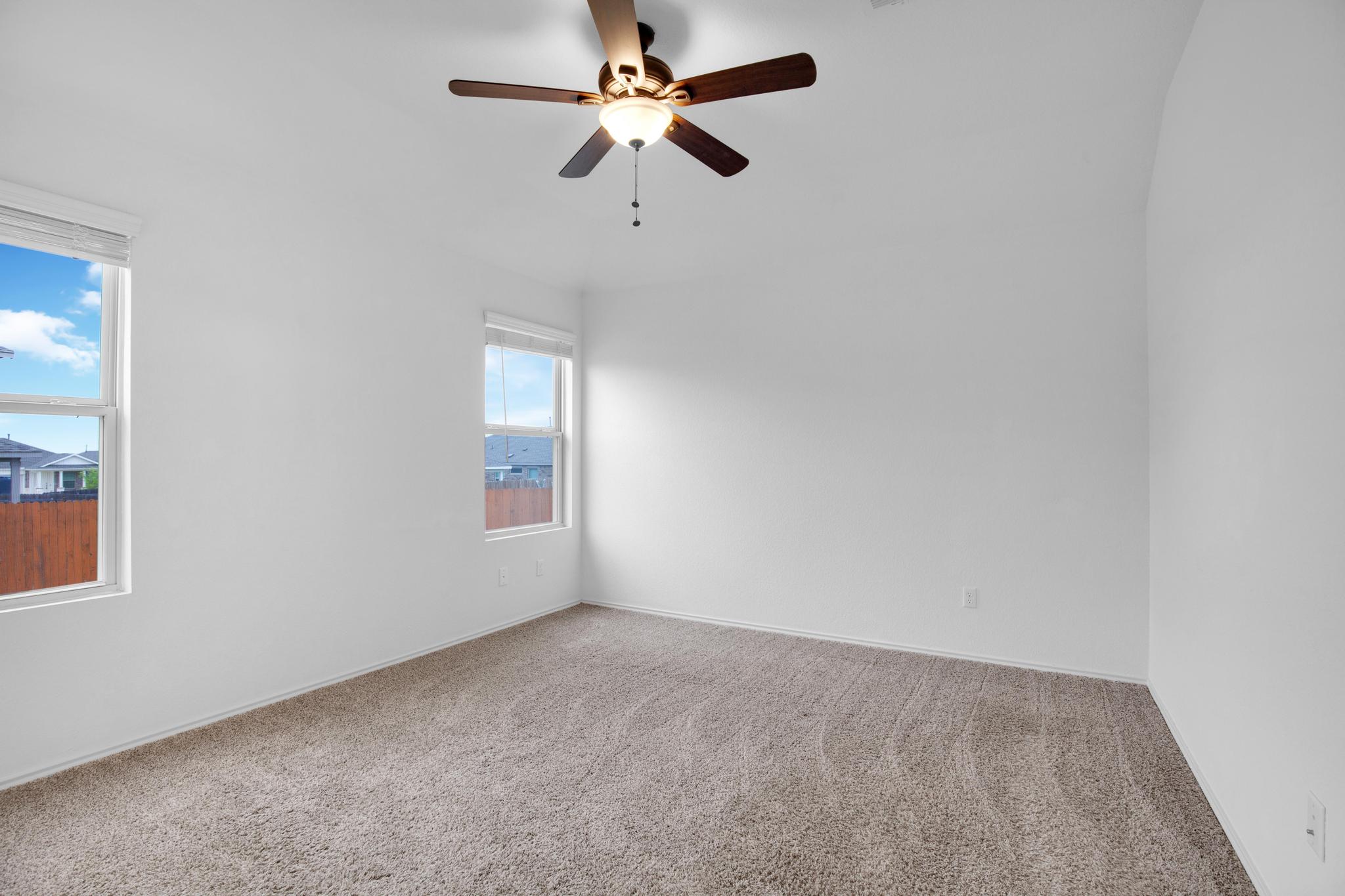 21409 Resource Road Pflugerville, TX 78660 - Photo 10 of 23 Empty room featuring a ceiling fan and light colored carpet