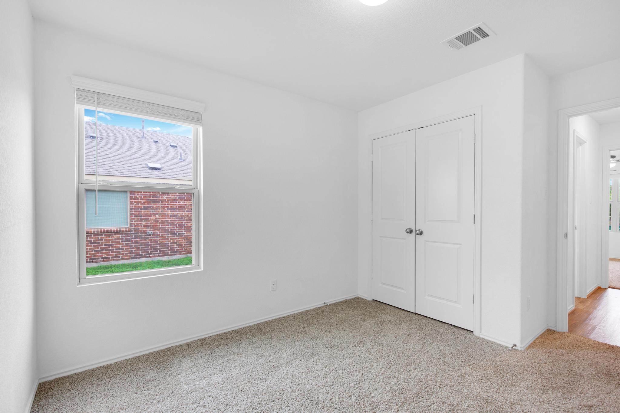 21409 Resource Road Pflugerville, TX 78660 - Photo 18 of 23 Unfurnished bedroom featuring light colored carpet and a closet