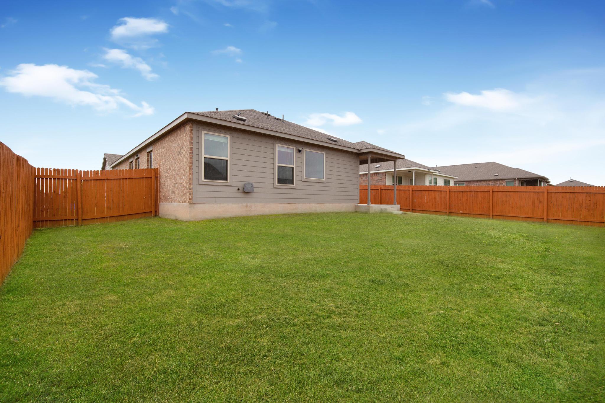 21409 Resource Road Pflugerville, TX 78660 - Photo 20 of 23 Rear view of property featuring a fenced backyard