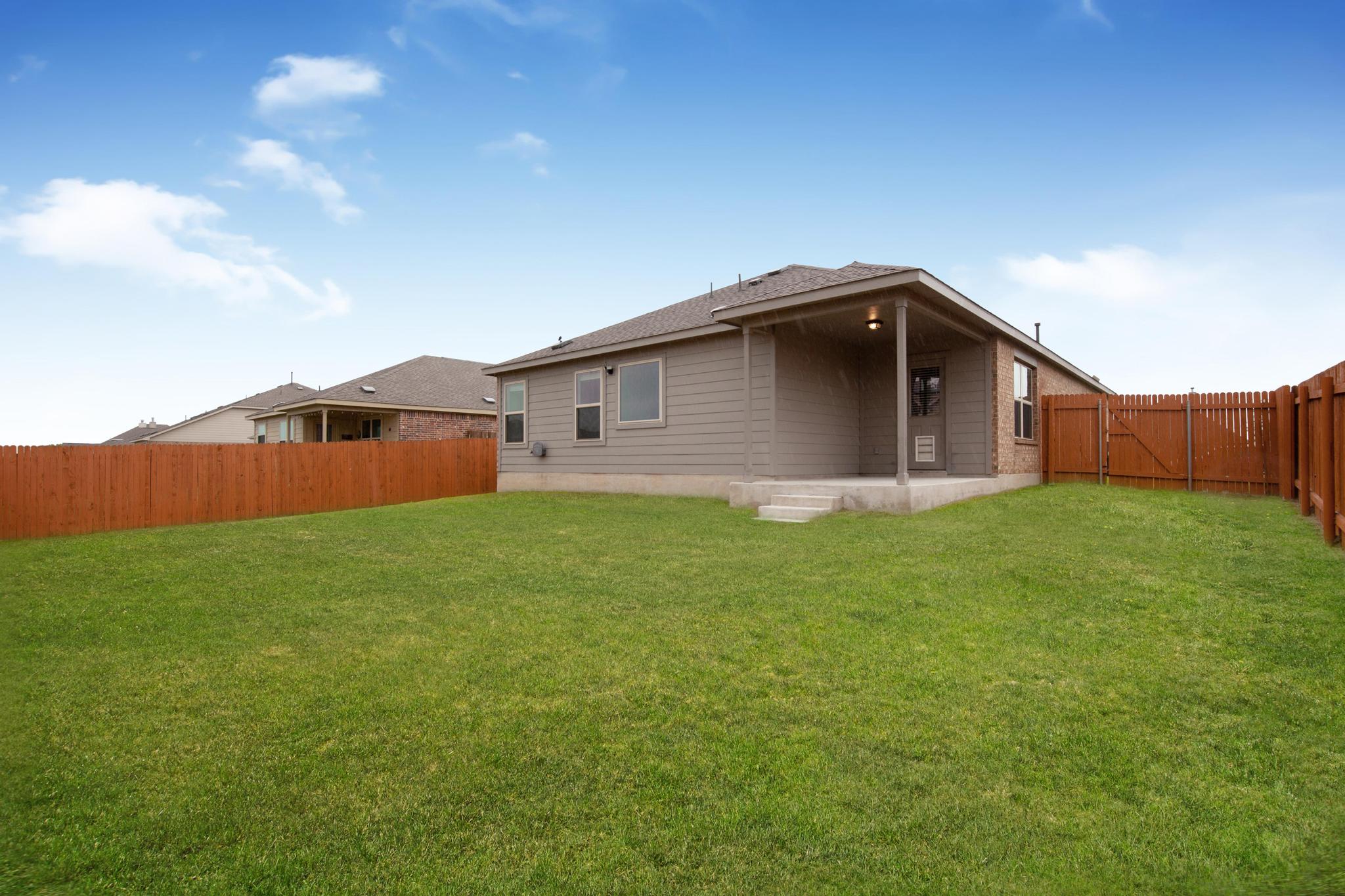 21409 Resource Road Pflugerville, TX 78660 - Photo 21 of 23 Back of house featuring a patio, a fenced backyard, and a gate