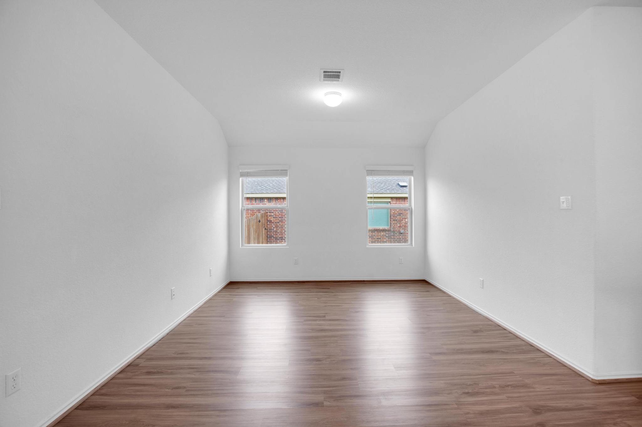 21409 Resource Road Pflugerville, TX 78660 - Photo 8 of 23 Empty room with dark wood-style floors and vaulted ceiling