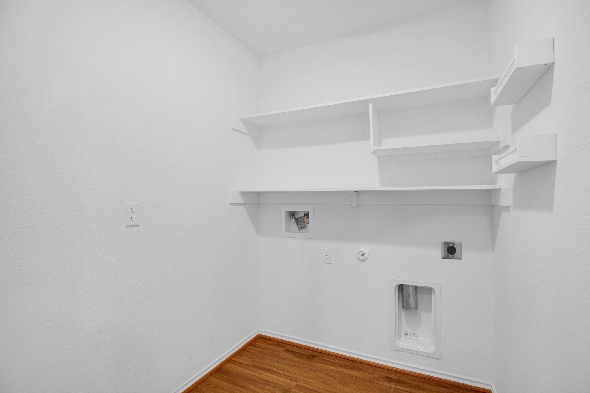 21409 Resource Road Pflugerville, TX 78660 - Photo 9 of 23 Laundry room with gas dryer hookup, hookup for an electric dryer, wood finished floors, and hookup for a washing machine