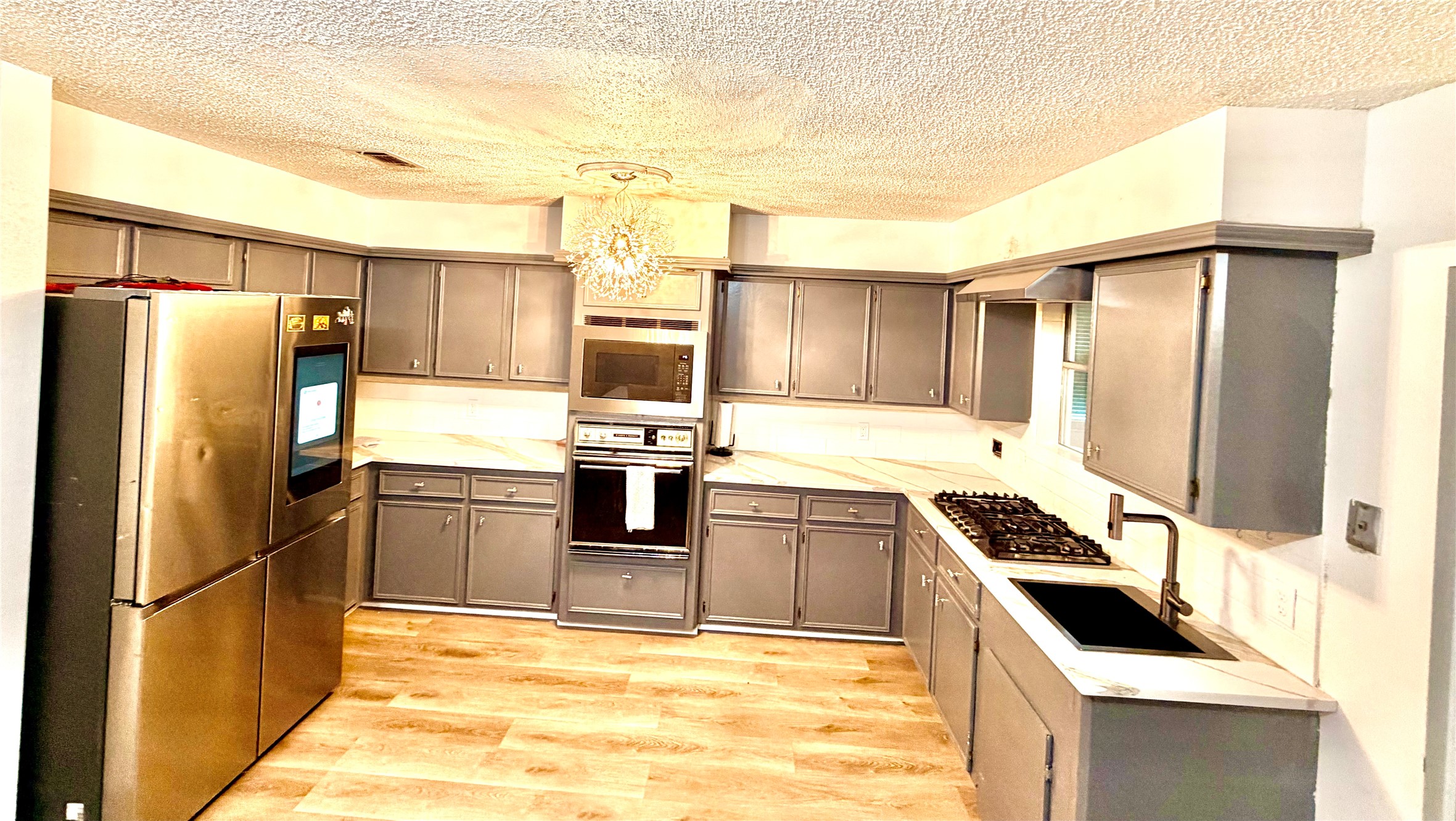 11635 Ridge Run Drive Houston, TX 77064 - Photo 7 of 20 a kitchen with granite countertop a refrigerator and a stove top oven