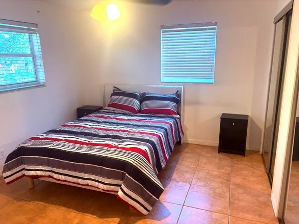 a bedroom with a bed and a window