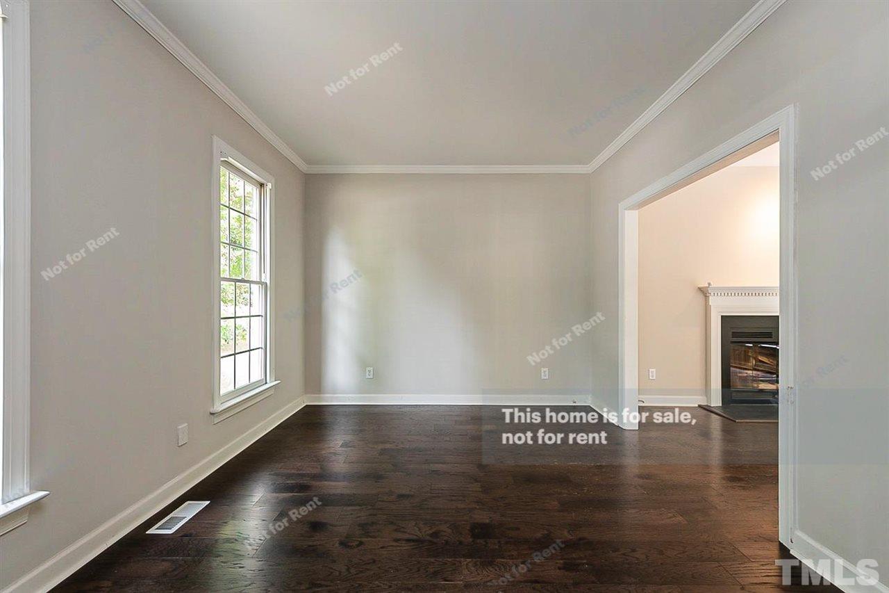 8528 Yucca Trail Raleigh, NC 27615 - Photo 11 of 21 a view of empty room with wooden floor and fan