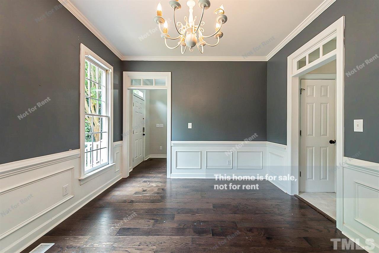 8528 Yucca Trail Raleigh, NC 27615 - Photo 13 of 21 a view of an empty room with wooden floor and a window