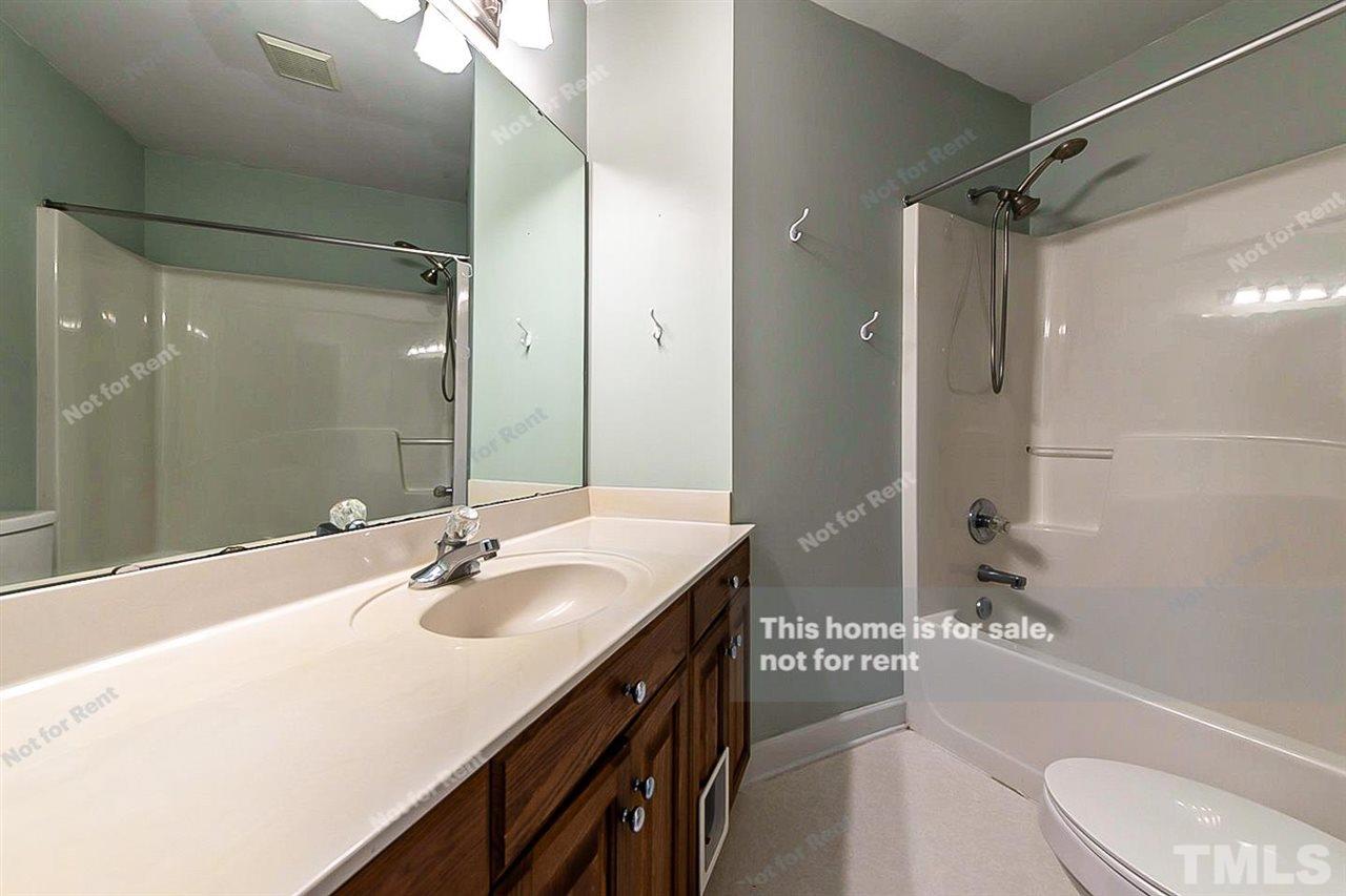 8528 Yucca Trail Raleigh, NC 27615 - Photo 18 of 21 a bathroom with a sink double vanity granite tub shower and a mirror