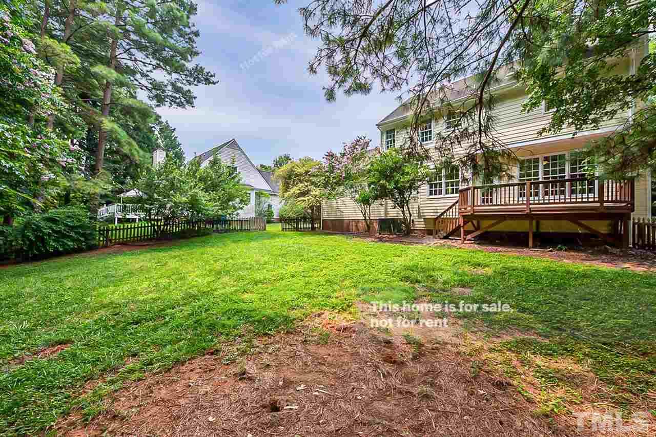 8528 Yucca Trail Raleigh, NC 27615 - Photo 20 of 21 a view of a yard with a bench and trees