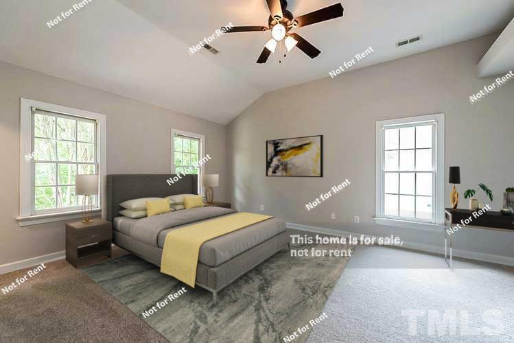 8528 Yucca Trail Raleigh, NC 27615 - Photo 3 of 21 a bedroom with a large bed and windows