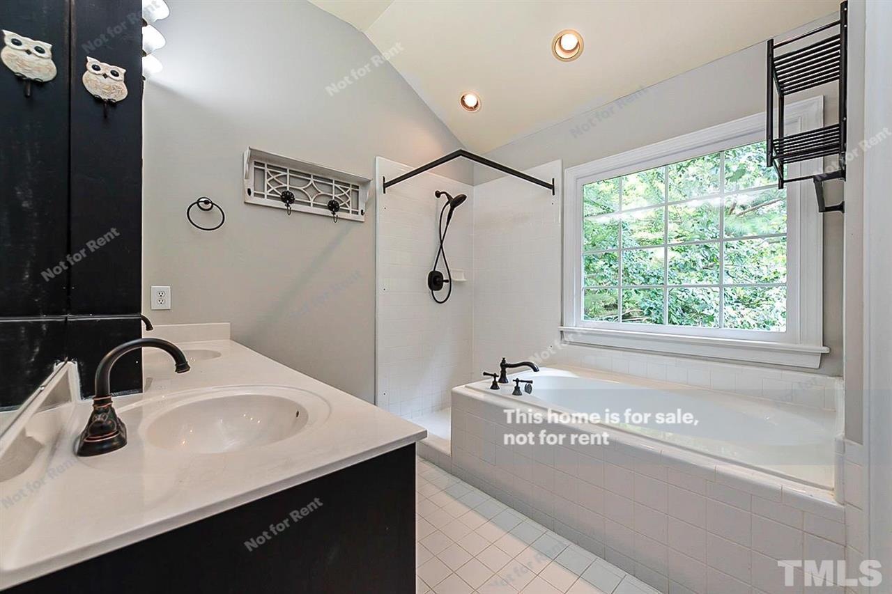 8528 Yucca Trail Raleigh, NC 27615 - Photo 6 of 21 a bathroom with a sink and a large mirror
