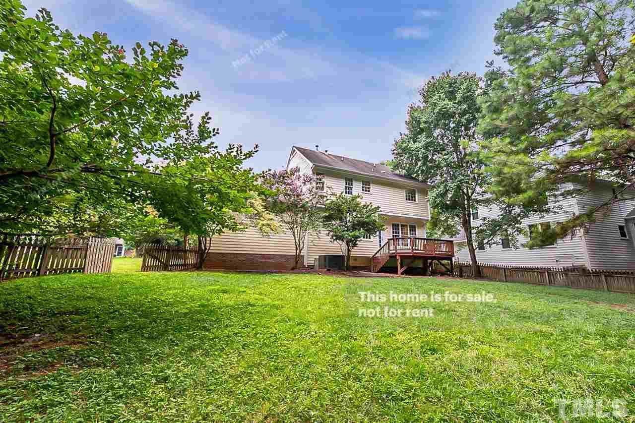 8528 Yucca Trail Raleigh, NC 27615 - Photo 7 of 21 a view of a house with a big yard and a large tree