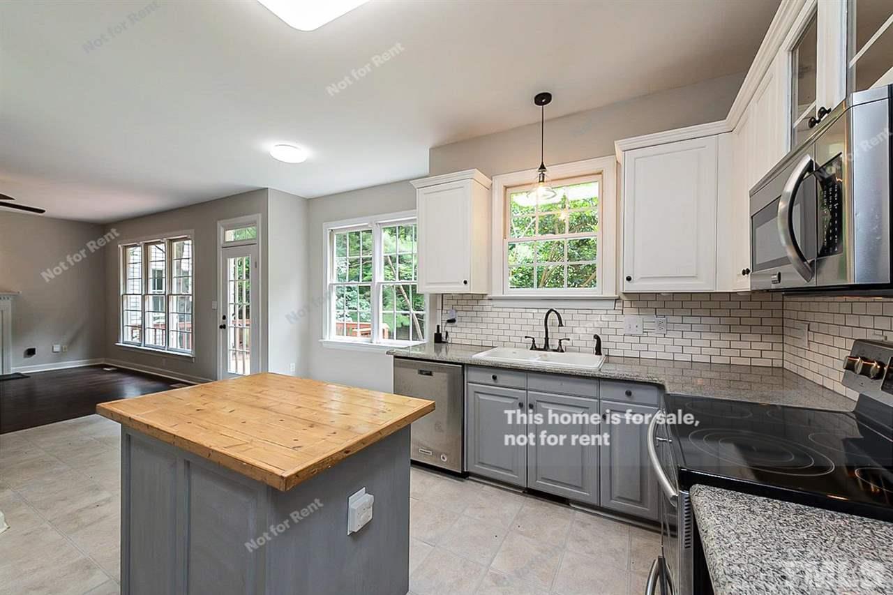 8528 Yucca Trail Raleigh, NC 27615 - Photo 8 of 21 a kitchen with a sink a counter space and a window