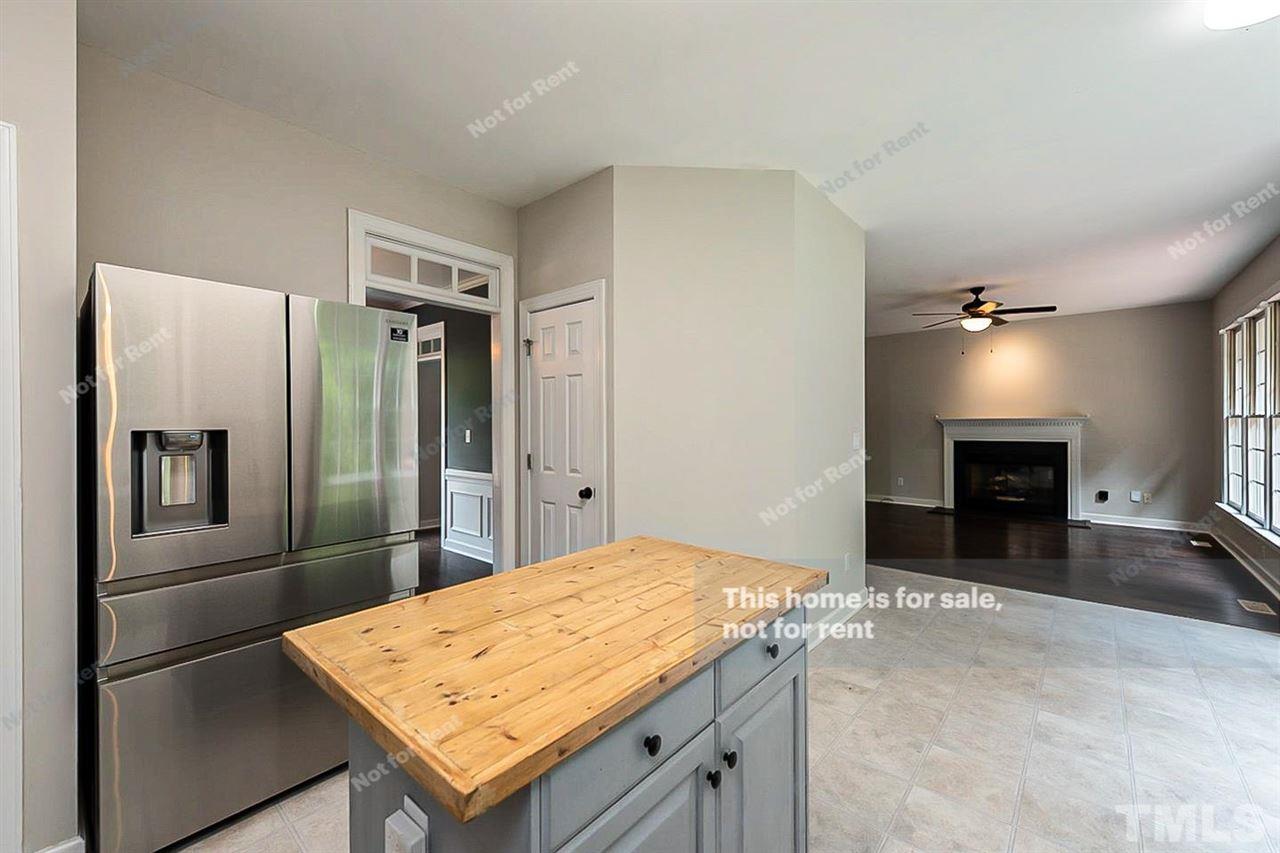 8528 Yucca Trail Raleigh, NC 27615 - Photo 9 of 21 a kitchen with stainless steel appliances kitchen island a refrigerator sink and stove